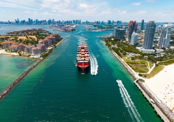 A cargo ship moving through a canal.