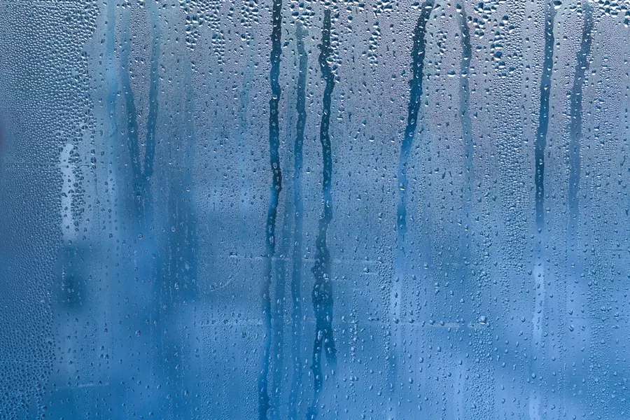 Glass thoroughly fogged and condensation-soaked by humidity.