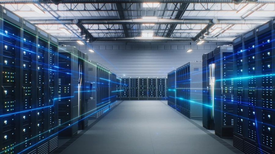 Tall rows of servers flanking either side of a pathway in a data center.