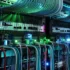 Part of a server rack in close-up, with network cables and glowing lights.